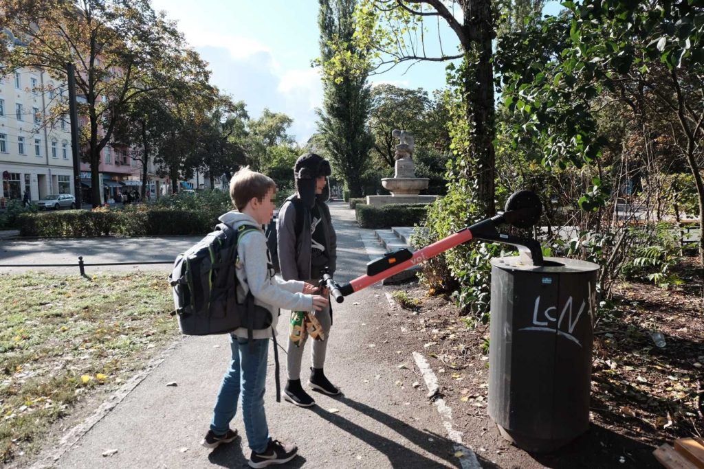 Kids disposing of an e-scooter