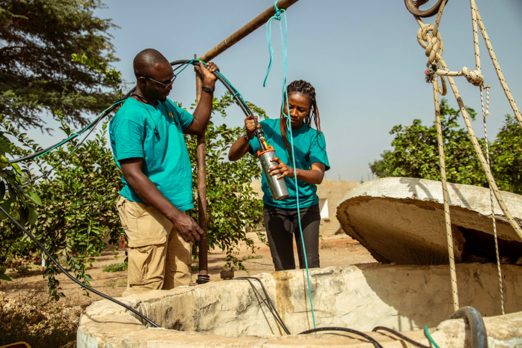 Two people mounting SolarWorX equipment in Sub Saharan Africa